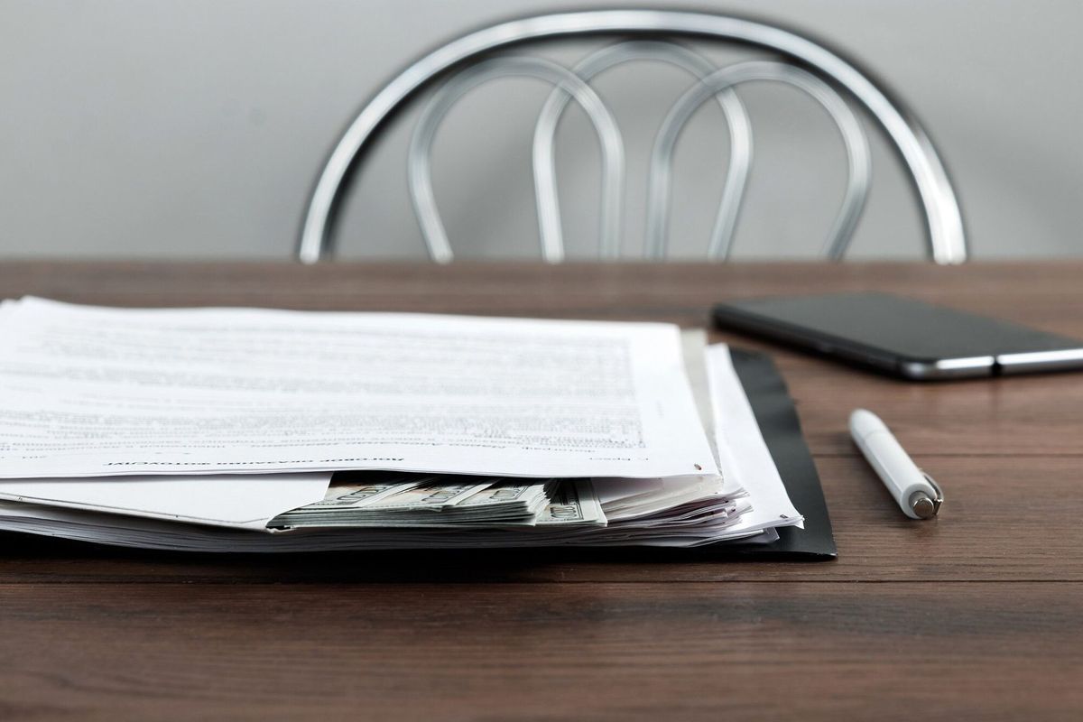 Money in the envelope lie on the workplace in the office.