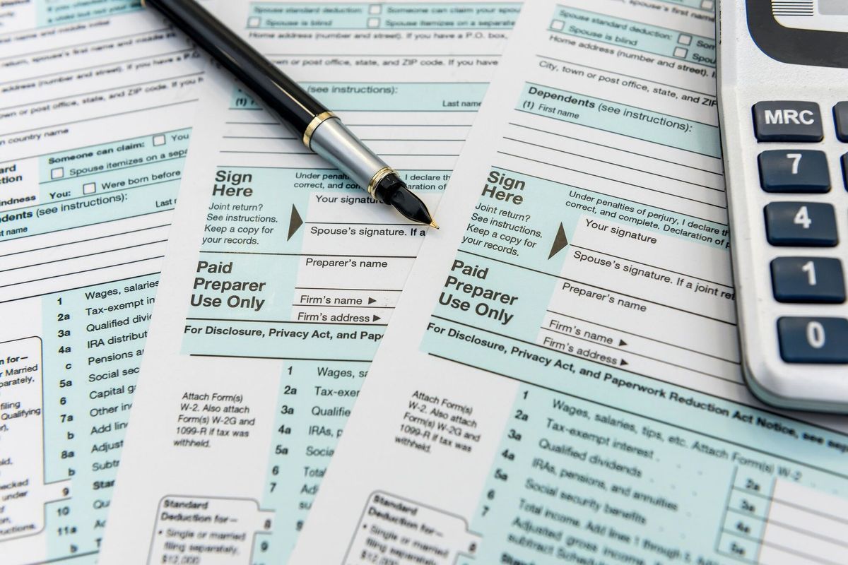 Time for tax, federal form with pen and calculator, office desk. Paperwork