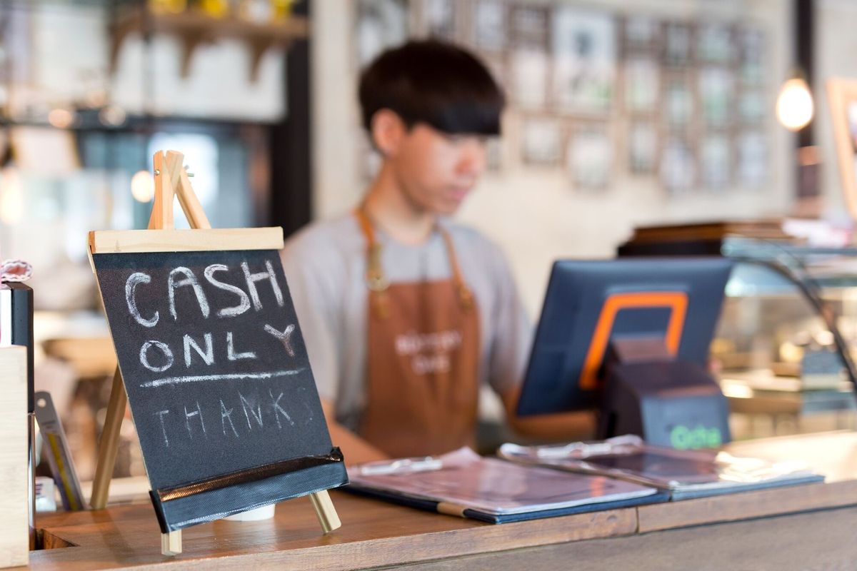 Conceptual black board on counter bar with text Cash onlt in cafe