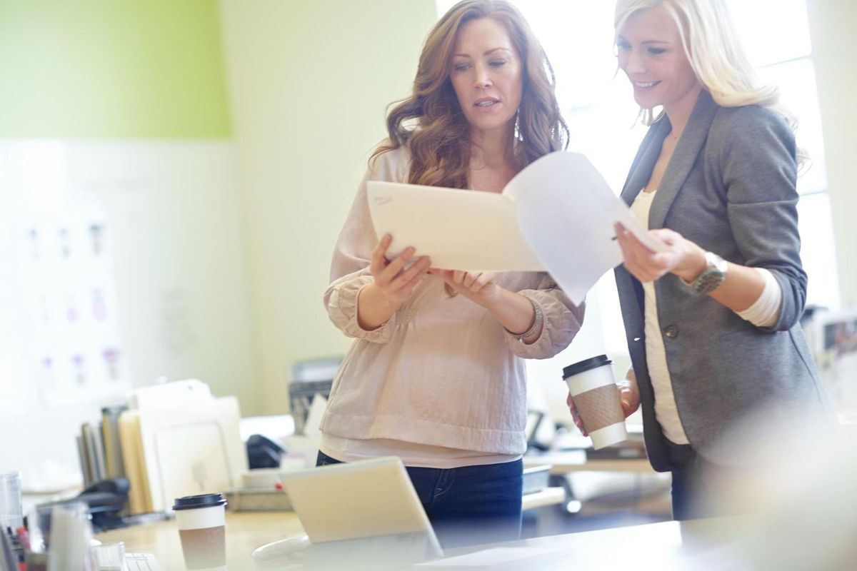 Happy accountant and employee in meeting with documents for planning ideas and budget proposal Business people paperwork and discussion collaboration and teamwork on financial report