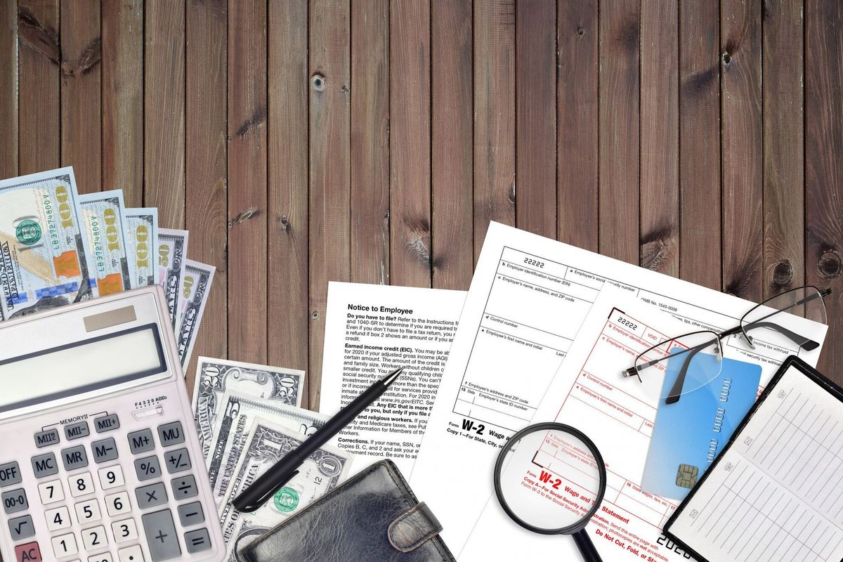 IRS form W-2 wage and tax statement lies on flat lay office table and ready to fill