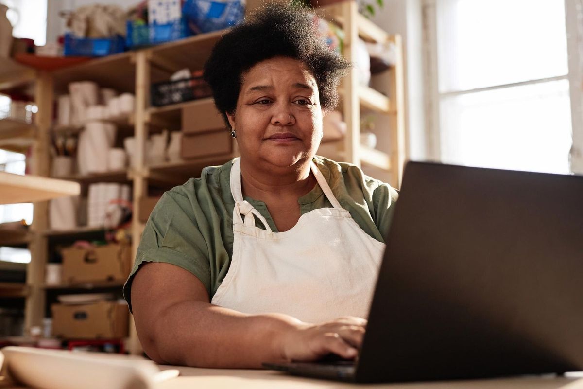 Black Senior Woman Using Laptop in Art Studio