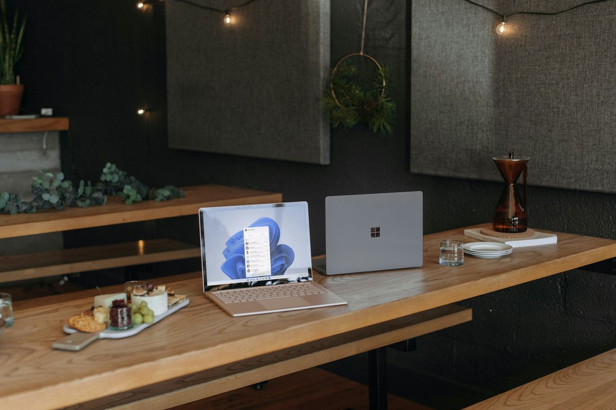 Two Microsoft laptops on a table in an office during the holidays